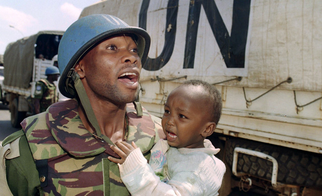 A UN peacekeeper holds a crying child, Rwanda. (Photo: AFP/Getty Images)