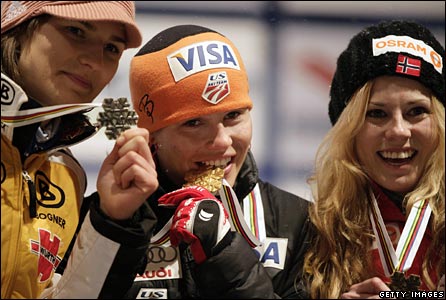 Germany's Urike Graessler , Lindsey Van of the US and Norwegian Anette Sagen show off their historic medals