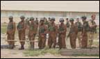 Iraqi tropps being trained by British service men.