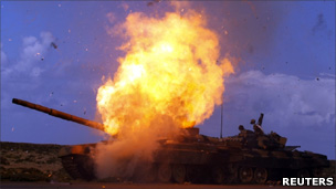 A tank belonging to forces loyal to Libyan leader Muammar Gaddafi explodes after an air strike by coalition forces