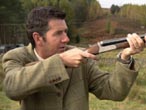Dougie Vipond aiming a shotgun
