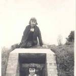 Marjorie standing in the doorway, her twin sister sat on the roof of the air raid shelter, aged nearly 13 years old. This photo was taken during the Summer term of 1941.