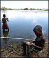 Boys fishing on ruined farm land
