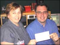 Stuart George presents a cheque to the Elizabeth Trust