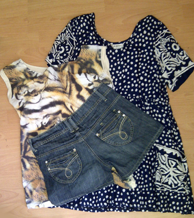 Catherine's swishing trophies: a cotton sundress, an animal print t-shirt, and a pair of denim shorts