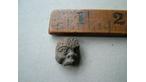 A piece of a pottery African head 