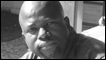 John Lata plays the part of Mr. Khumalo
