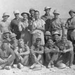 No. Platoon N.M.R., at Gazala, June 1942. From left to right back row standing: Ralph Humphries, Piet de Beer, Lieut. Ken Clarke, Brian Lloyd, Cary Nash, Mousie Bell, Cecil Ritson, Johnny Clark. Middle row seated: Jock Reen, Joe Cowley, Ray Lee, Unknown, Jimmy Shrimpton, Douglas Baker. Front row, Derek Street, Cowboy Drennan, Walter Beangstrom, Roger Ellis, Charlie Roper.