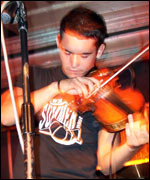Tom, vocalist and violinist in Story One