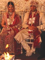Hindu wedding ceremony in which bride and groom sit on chairs before the ceremonial fire