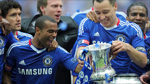 Chelsea's players get their hands on the FA Cup trophy at Wembley last year.