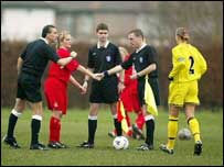 referees shaking hands with players before a game