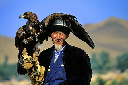 Man holding an eagle, photo by Tom Ang