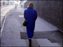 Woman walking along an empty street