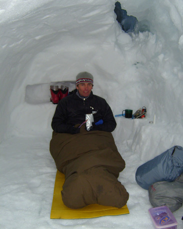 Mountaineer sitting up inside snow-hole (Image courtesy of John Armstrong, Glenmore Lodge)
