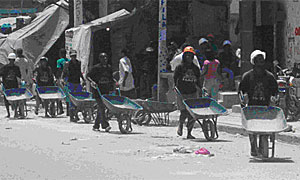 Workers with wheelbarrows in Port-au-Prince