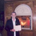 Harold Limeburner holding the Roll of Honour open to the page of his brother Jack's name.