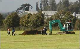 Mechanical digger and soil heap