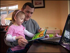 Brian reads his book to one of his daughters