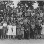 Jim is eight from the right, front row, holding a mug