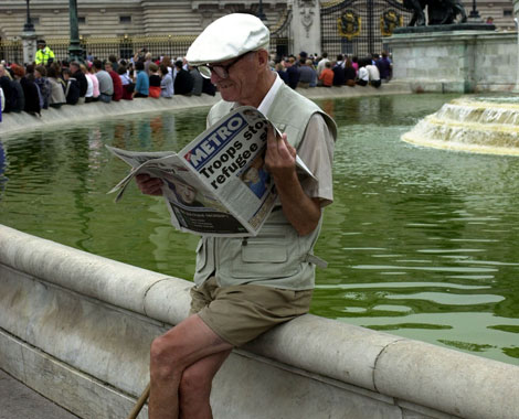 Elderly man reading a newspaper