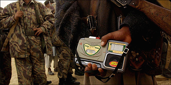 A soldier holds a radio 