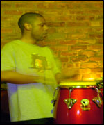 Young man playing the bongo drums