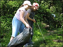 Children litter picking around the pond area