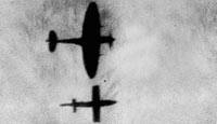A German V-1 missile and a British fighter plane silhouetted against the sky
