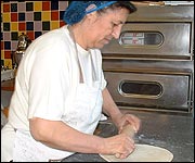 Rolling out dough for Turkish pizza