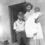 The firm bond that began during the war has continued through the years. Here, in 1950 Patricia returns to visit, for the christening of Pamela Cole, Micheal's baby sister. Michael pictured age 7