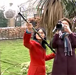 Two people using video and sound equipment