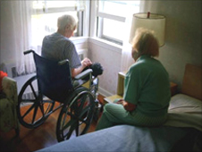Two people looking out of a window