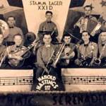 Harold Hastings and his Band at the Stammlager XXID prisoner of war camp in Poznan, Poland, 1942. Archie Derrick is third from right on the front row, holding saxaphone
