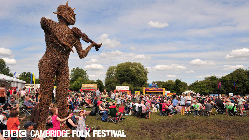 The Cambridge Folk Festival wickerman stands proudly over the festival masses.