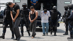 Members of Mexixan drug cartel 'La Familia Michoacana' are escorted by police in Mexico City