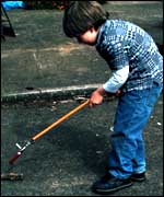 Solomon plays with one of the gardening tools.