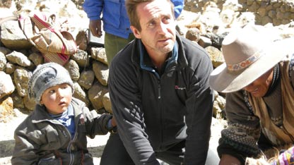 Bruce holds sheep during sacrifice