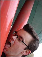 Man licks a post 