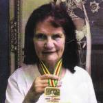 Elma Kent, former Japanese POW, with her medal from the London Marathon 2005.