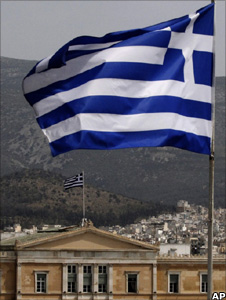 Greek flag flies from the roof of a building as the house of Parliament, Athens