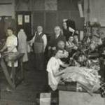 Dad's factory at Gt.Eastern Street. Jack is wearing a tie, Dad is wearing an apron, I am fixing a machine and Lou is opposite me.