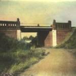 THIS IS A PHOTOGRAPH OF A RAILWAY BRIDGE IN TORNAUI. THIS WAS No. 3 BREN CARRIER SECTIONS POSITIONS FROM MAY 13TH. TO MAY 21ST. 1940. IT WAS AT THIS POSITION THAT THE FOLLOWING MEMBERS OF THE PLATOON WHERE LOST. Lt. FITZGERALD WAS KILLED, I BELIEVE BY FIRE FROM A MG38 MACHINE-GUN WHICH CAME THROUGH UNDER THE BRIDGE. IT ALSO SEVERED SOME OF THE SIGNAL CABLES RUNNING BENEATH THE BRIDGE. MY FATHER REMEMBERED STANDING BY THE CARRIER ONE MINUTE AND BEING INSIDE THE NEXT, WITHOUT ANY RECOLLECTION OF HOW HE GOT THERE. Sgt. BECKET, Sgt. TODD AND PRIVATE WILSON WHERE KILLED ON THE TOP OF THE RAILWAY EMBANKMENT. THEY WHERE TRYING TO SEE WHERE THE GERMAN FIRE WAS COMING FROM. FINDING IT DIFFICULT TO SEE OVER THE OTHER SIDE BECAUSE OF THE WIDTH OF RAILWAY TRACKS, ONE OR MORE OF THESE MEN EXPOSED HIMSELF TOO MUCH AND WAS HIT BY FIRE IN HIS AMMUNITION POUCH SETTING OFF A GRENADE THAT KILLED THREE OF THE MEN.