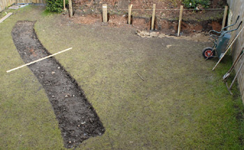 The transformation begins. The path has been dug and the posts are in.