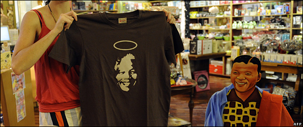 Woman holding Mandela is a saint T-shirt