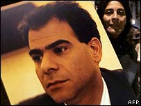 A woman carrying the picture of assisinated Minister, Pierre Gemayel