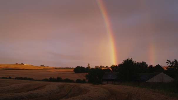A double rainbow, grey sky and bright sunshine surround Balgove