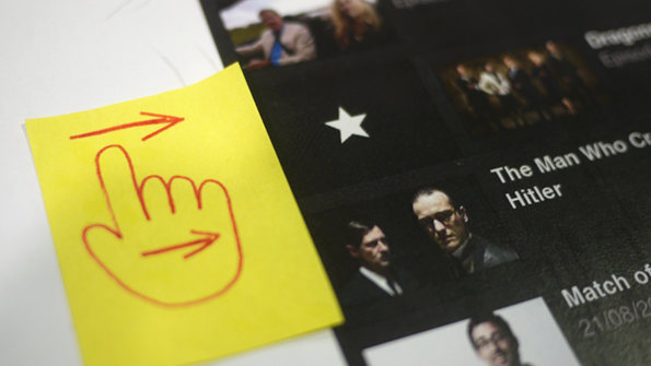 a sticky note with a hand on it next to a star icon, on a printout of a mockup of an episode list screen