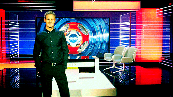 Dan Walker poses in front of the new Match of the Day studio at Media City in Salford