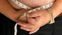 Close-up of a man measuring his waist size